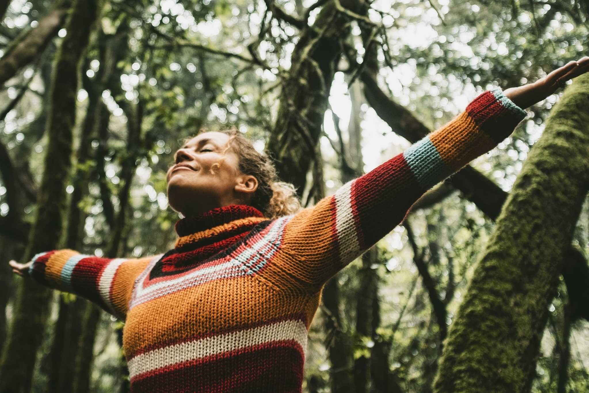 woman happy with open arms freedom forest