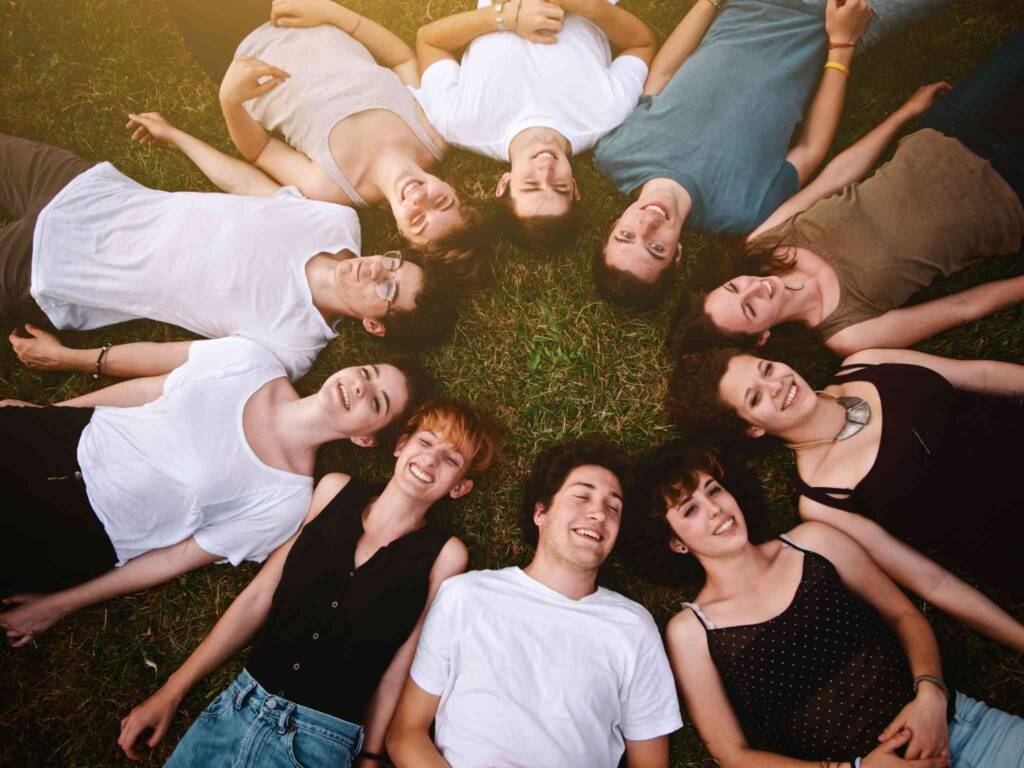 happy friends in a circle on the ground