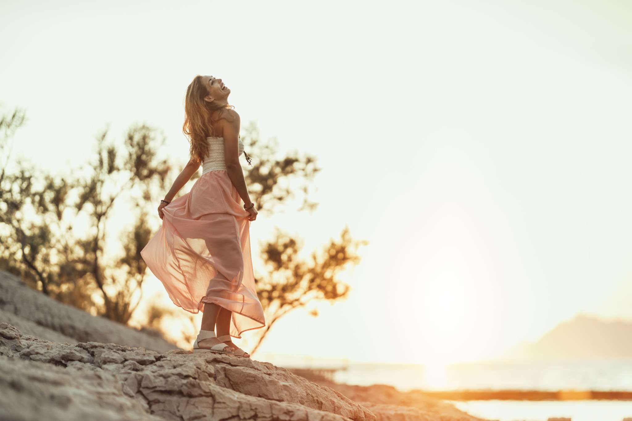 happy woman in pink by the beach