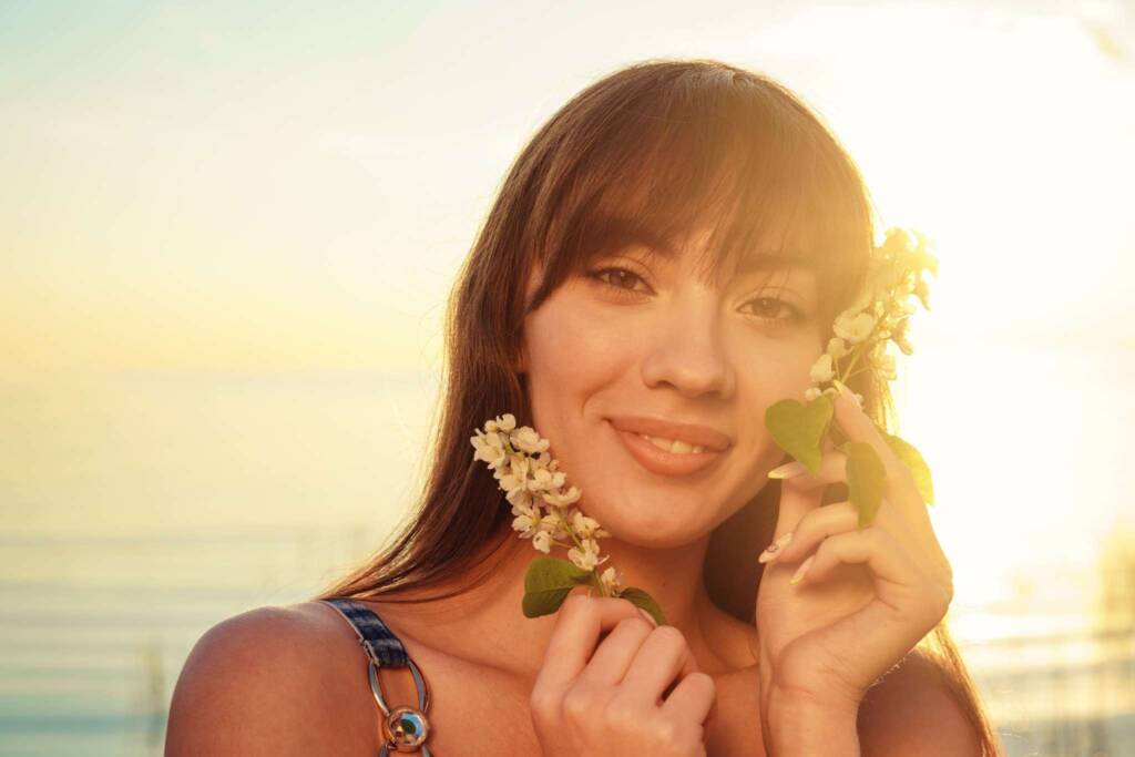 soft beautiful face of a woman portrait smiling with flowers