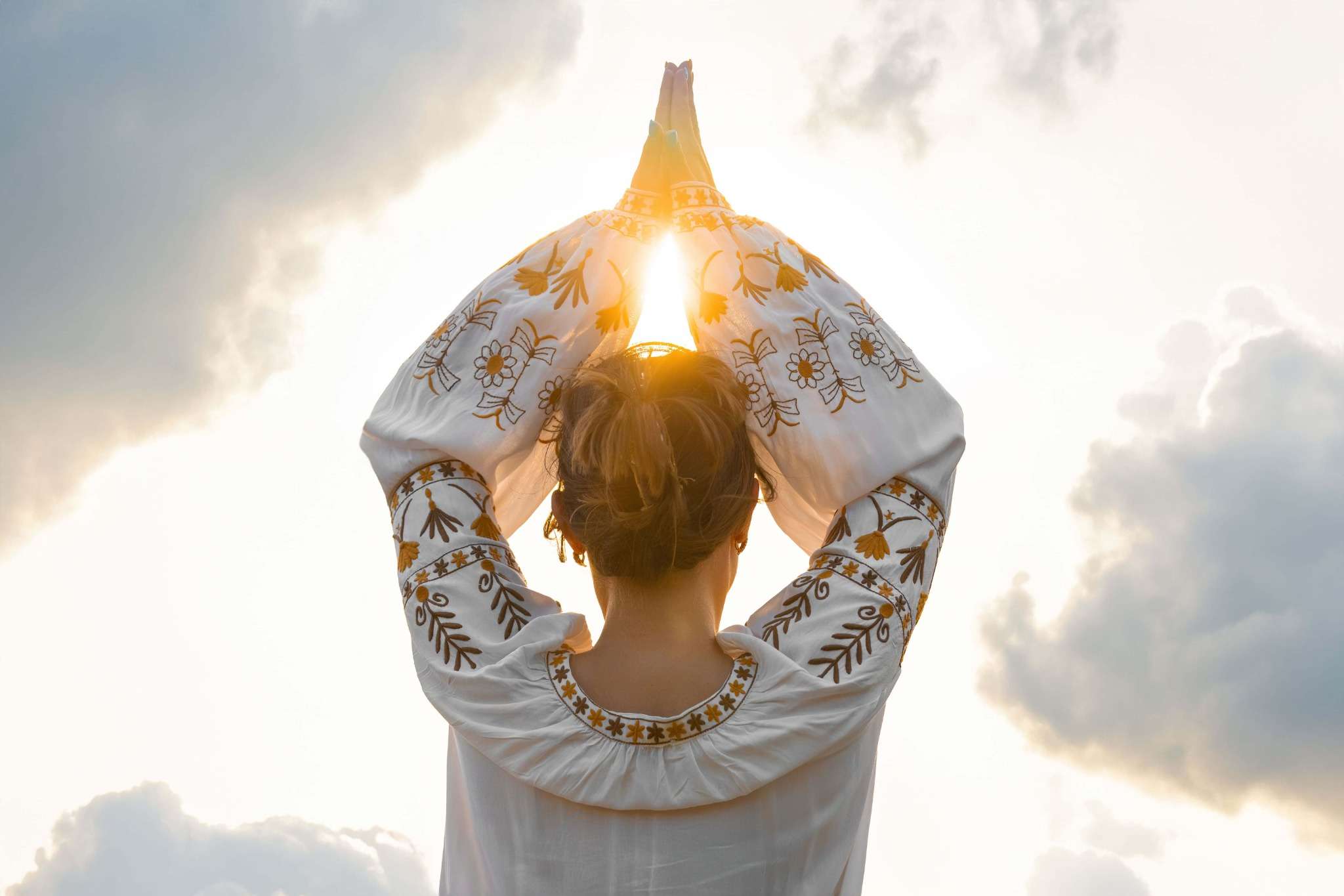 woman praying meditating yoga pose back side
