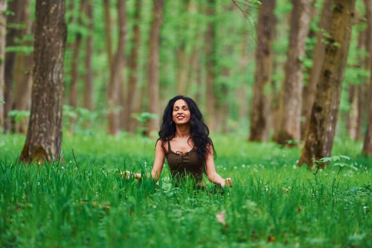 woman meditating in forest